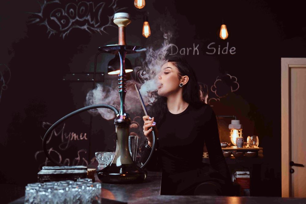 1 smokes-hookah-while-sitting-counter-nightclub
